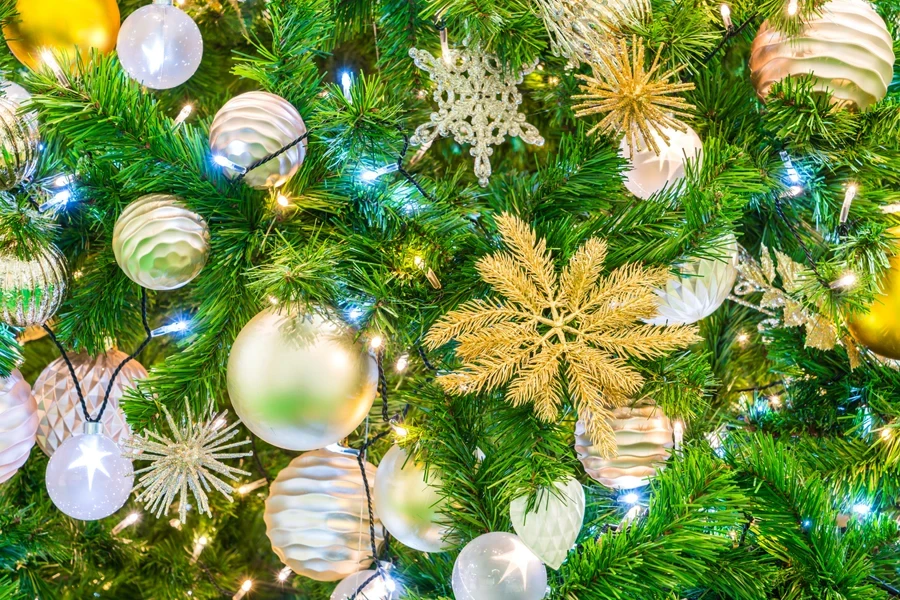 Beautiful, shiny, gold and white decorations on a Christmas tree