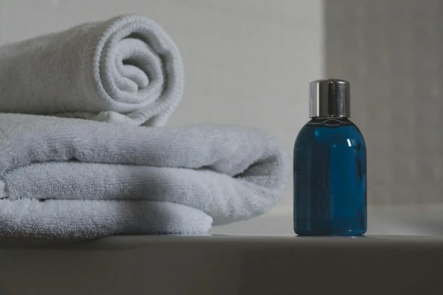 Blue Glass Bottle Beside White Towel