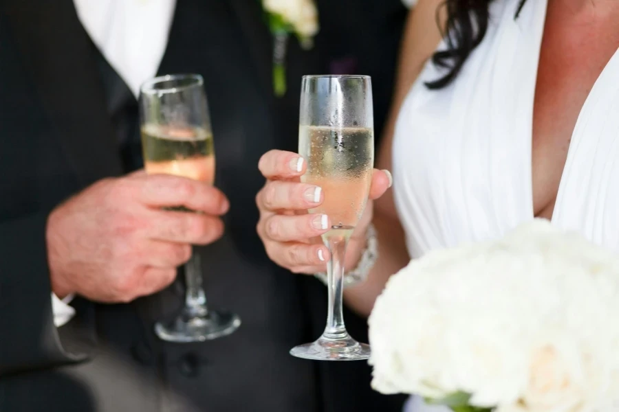 Bride and Groom Holding Glasses of Champagne