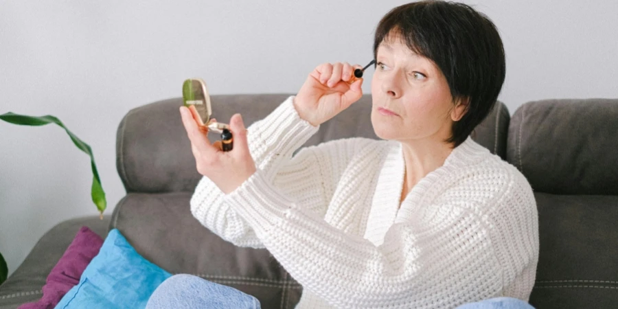 Close-Up Shot of a Woman in White Cardigan Sitting on Couch