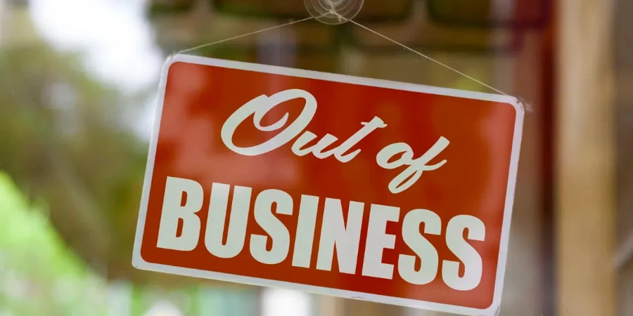 Close-up on a red sign in the window of a shop displaying the message