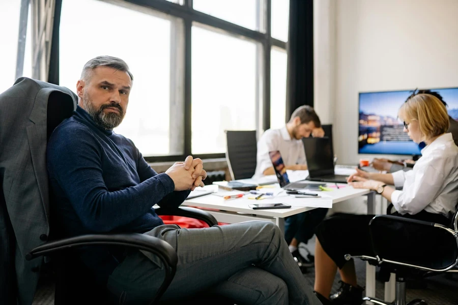 Co-workers engaging in a business discussion in a modern office setting