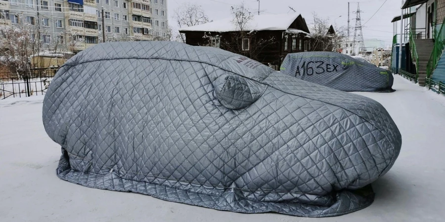 Covered Cars on Parking Lot in Town During Winter