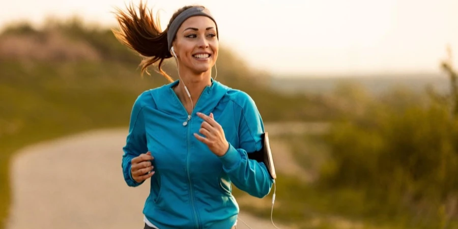 Dedicated Athletic Woman Running in Nature and Dawn