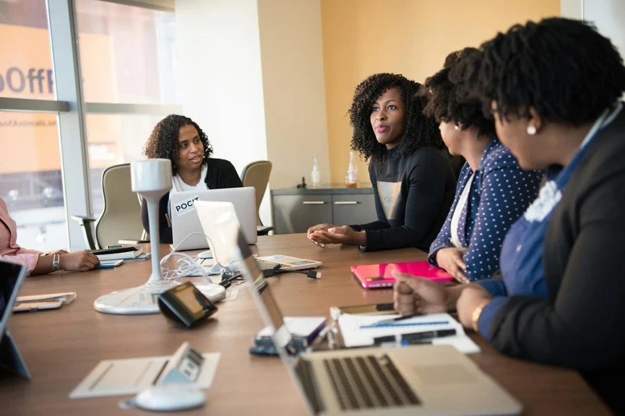 Diverse team of professionals engaging in a collaborative office meeting around a desk