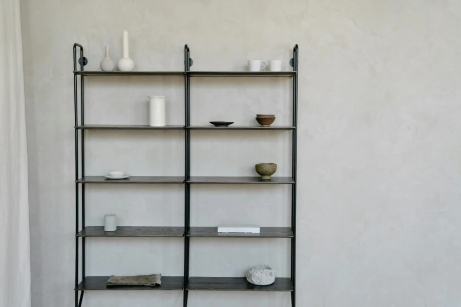 Elegant minimalist style shelving with pottery and books in a modern interior