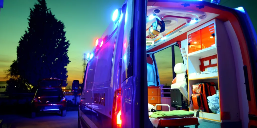 Emergency ambulance operating during sunset