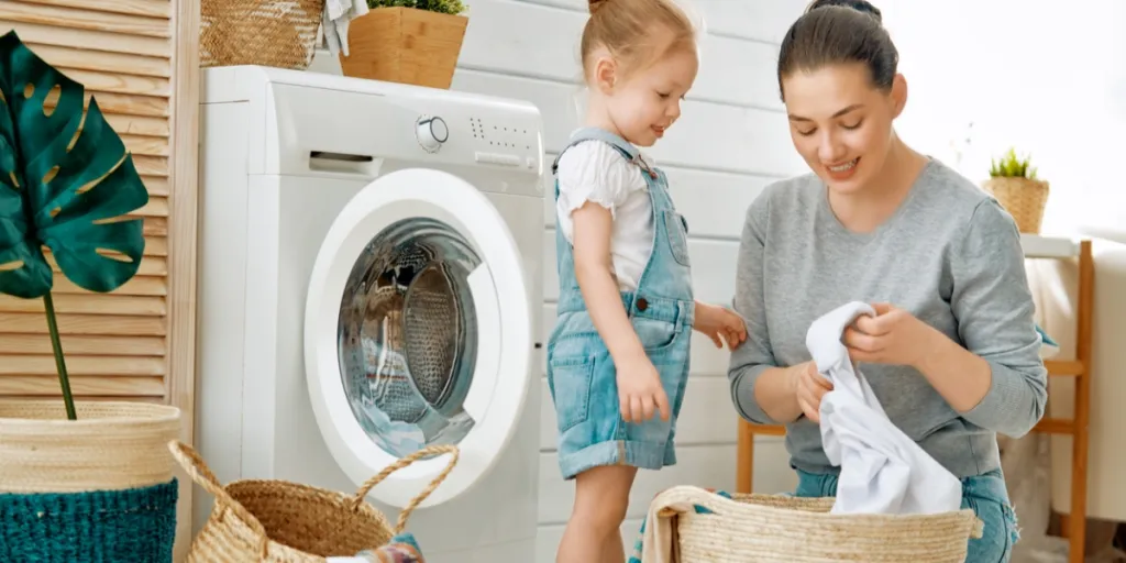 Family doing laundry in front of a front-load washer