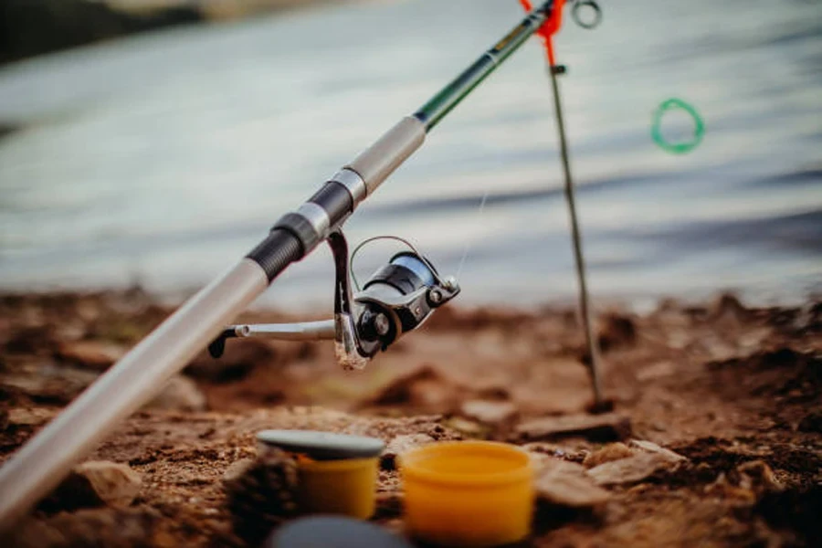 Fishing rod setup with fishing accessories around it