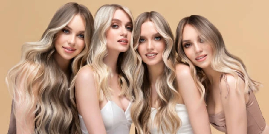 Four Young Women with Elegant Long Hair Dyed in the Shades of Blonde