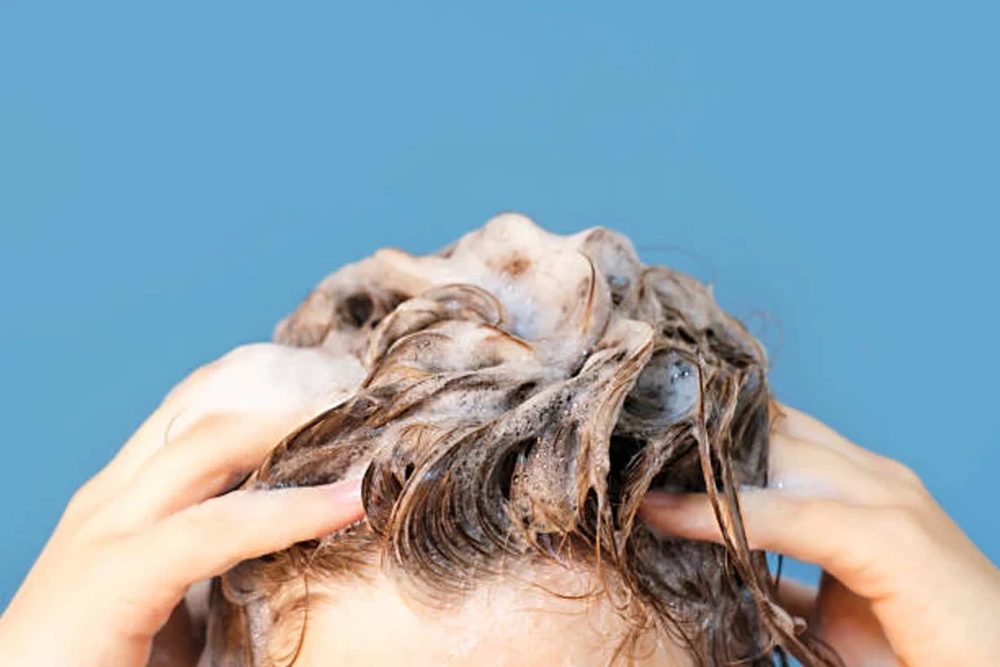 Girl Washes Her Hair with Shampoo