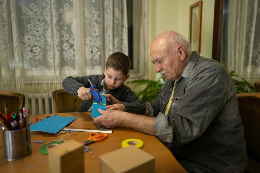 Grandson making a school project