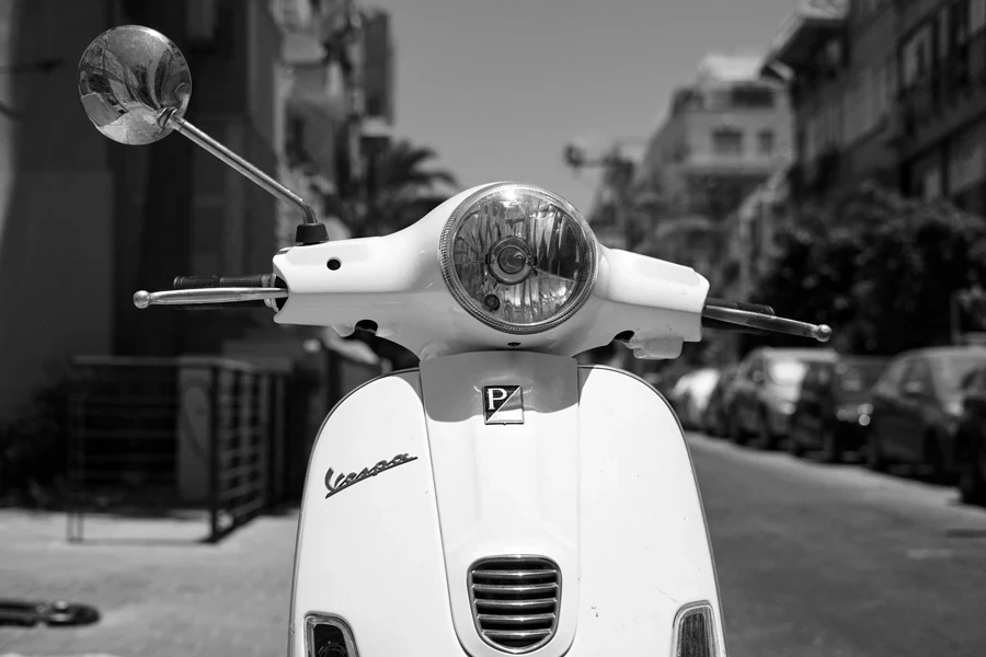 Grayscale Photo of a Vespa Lx Scooter