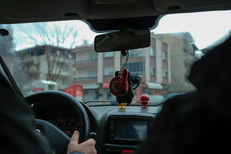 Hand on Steering Wheel of Car