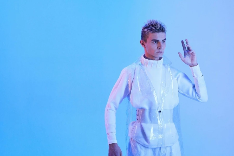 Man Wearing a Futuristic Outfit Posing in Studio in Blue Lighting