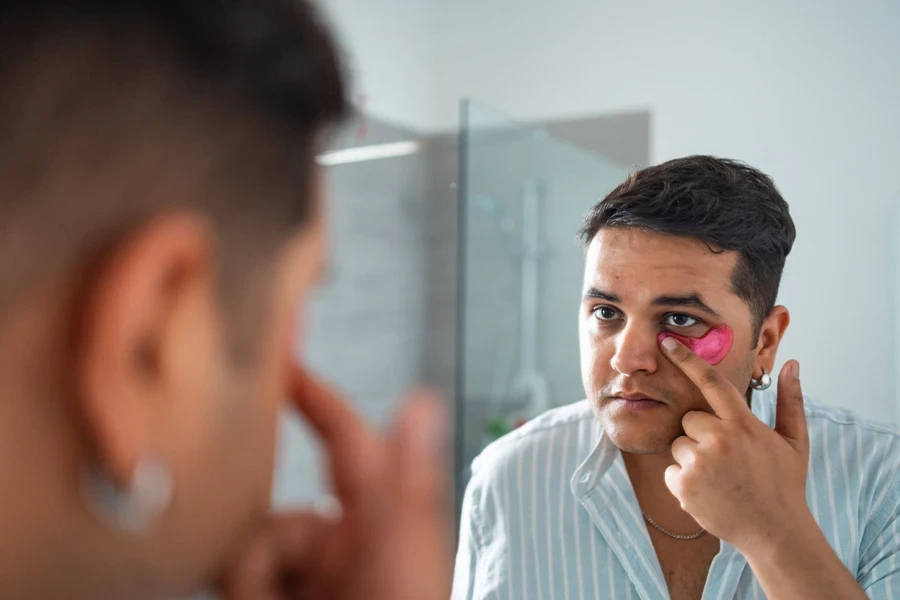 Man applying under eye mask