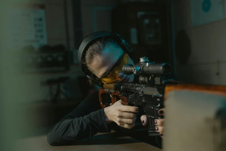 Man in Black Leather Jacket Holding Black Rifle