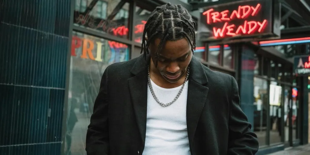 Man in a black coat with braided hair