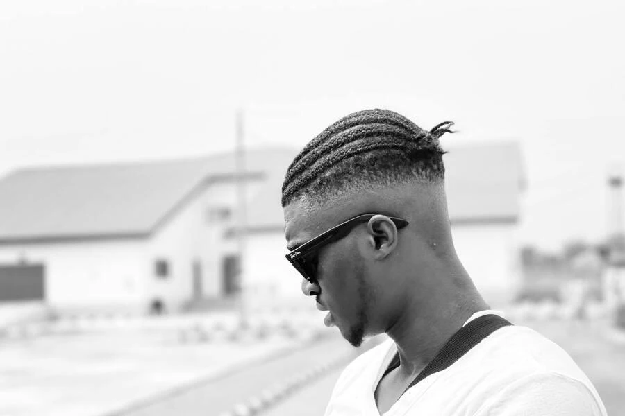 Man in braided hair with a fade