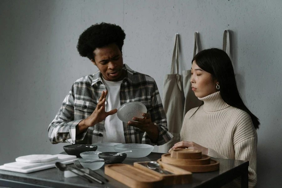 Man selling crockery to a woman