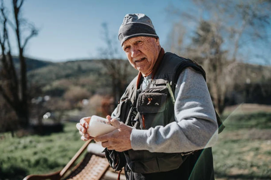 Man wearing outdoor gear preparing fishing daily schedule