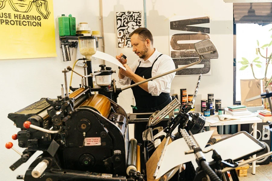 Man working with a printing machine