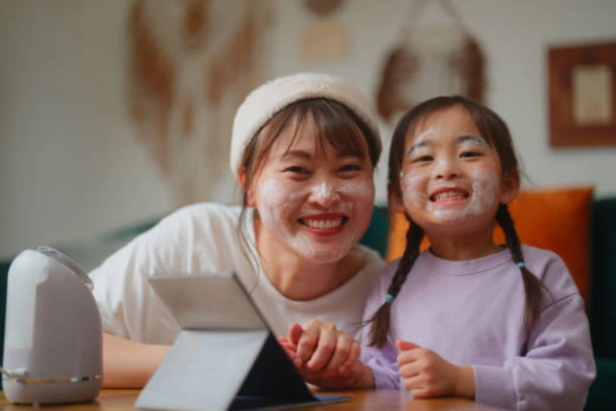 Mother Enjoying Doing Beauty Care and Relaxing with Her Small Daughter in the Living Room