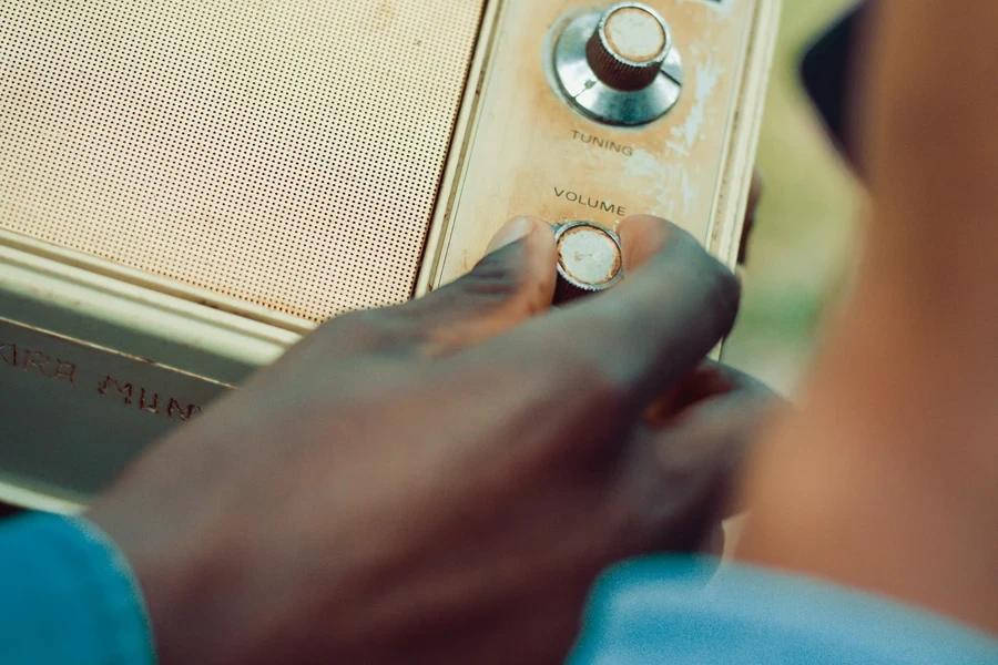 Person Holding Volume Knob