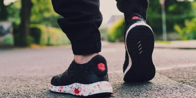 Person in Black Sneakers Walking on Street