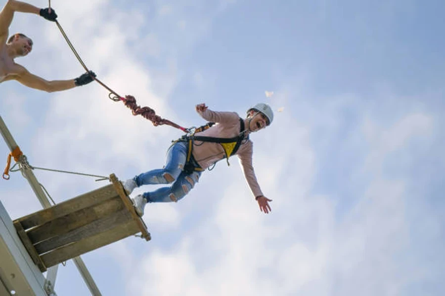 Person jumping from starting point attached to bungee cords