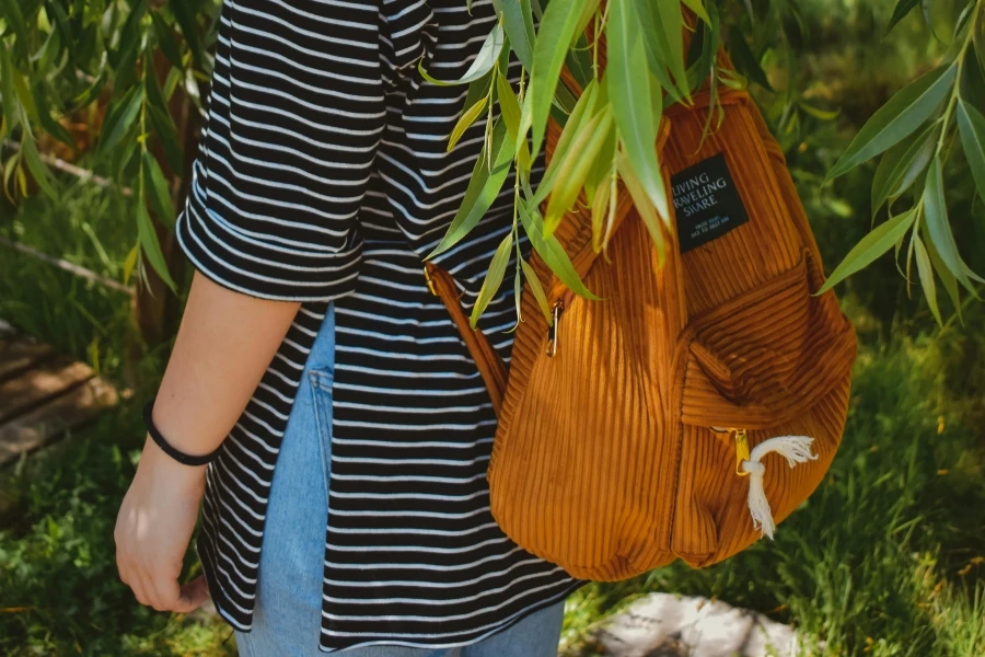 Person wearing tan corduroy backpack