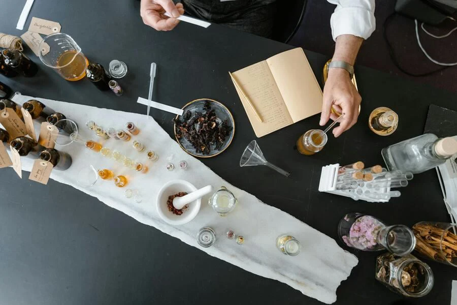 Person working with various small bottles and ingredients