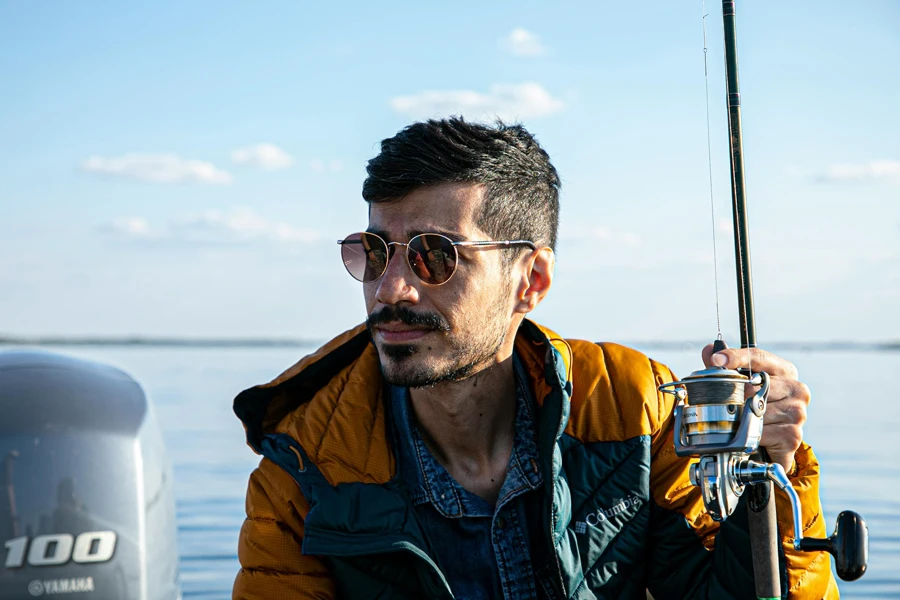 Photo Of Man Holding Fishing Rod