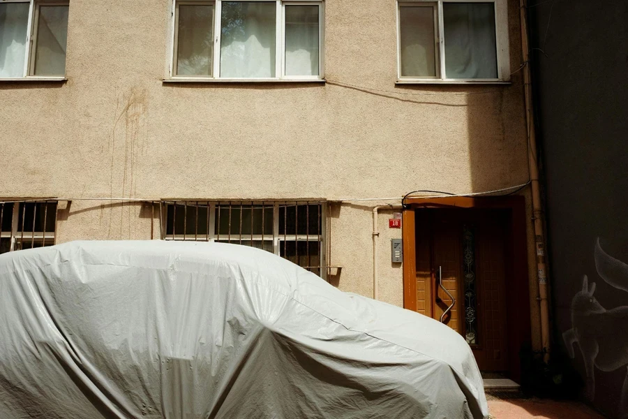 Photo of a Covered Car in front of a Building