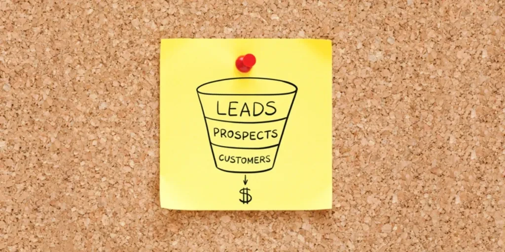 Sales funnel concept sketched on a yellow sticky note