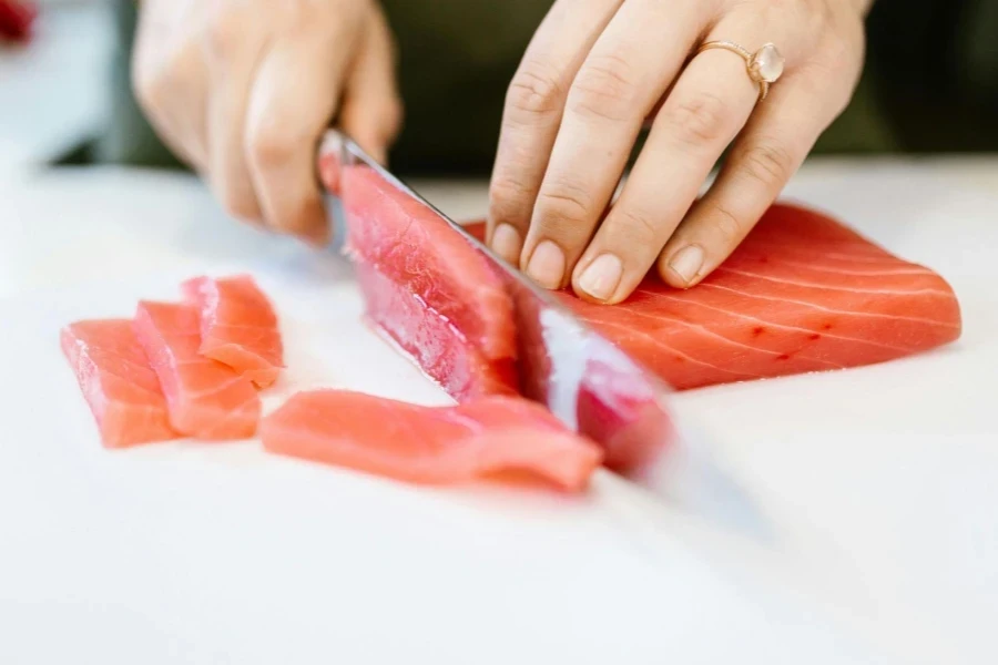 Slicing Raw Fish in Close-Up