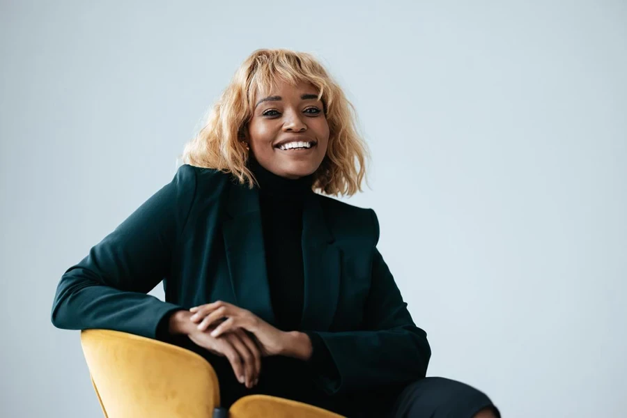 Smiling Blonde Businesswoman Sitting in an Office Chair