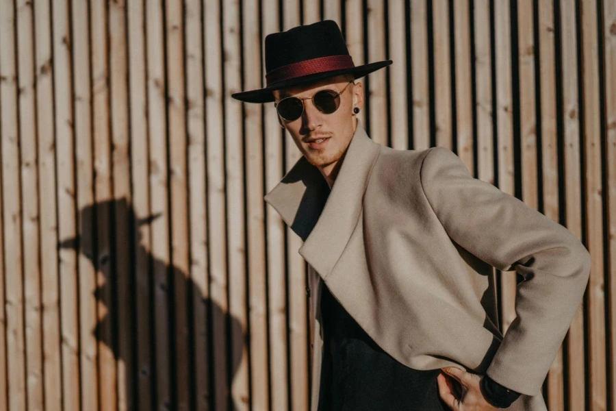 Stylish Man in Beige Coat and Fedora in Sunlight