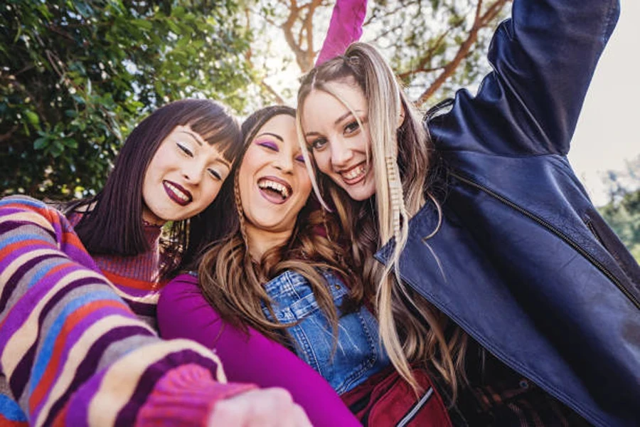 Three girls wearing colorful pastel makeup looks in spring