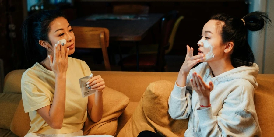 Two Women Applying Skincare Cream to Their Faces