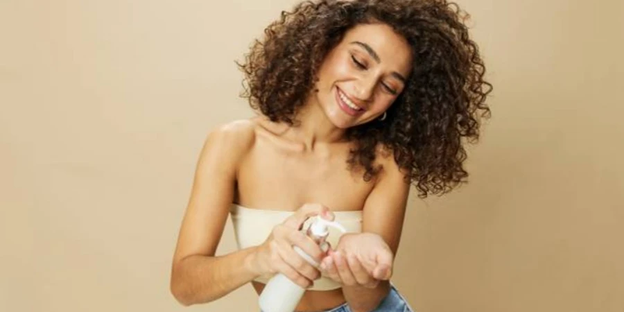 Woman Applies Lotion to Her Curly Hair