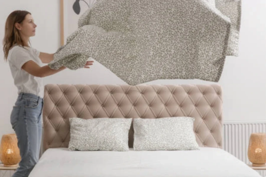 Woman Changing Bed Linens at Home