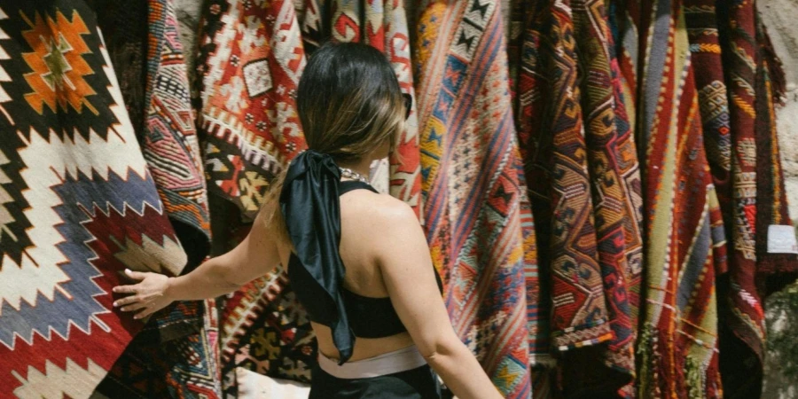 Woman Shopping for Blanket at Market