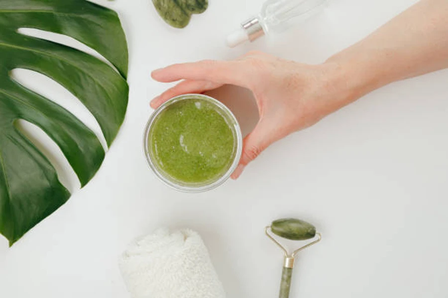 Woman Taking Jar with Cosmetics Green Natural Scrub