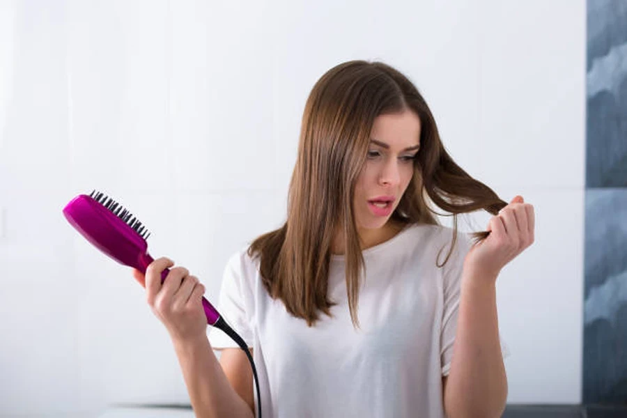 Woman Using a Hot Brush to Straighten Her Hair