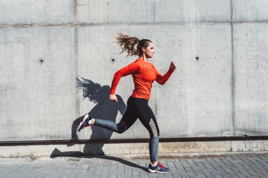 Woman in Jogging Outfit Running Outdoors