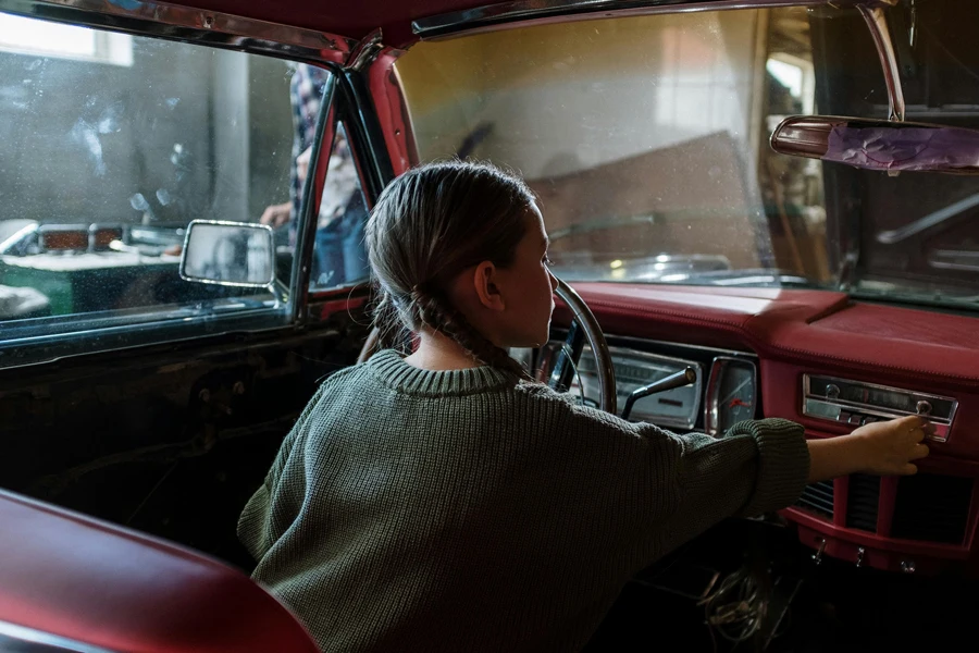 Woman in White and Black Sweater Sitting Inside Car