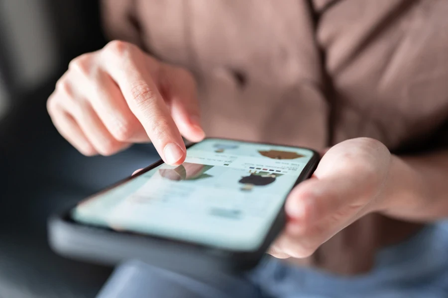 Woman shopping for clothes on a smartphone