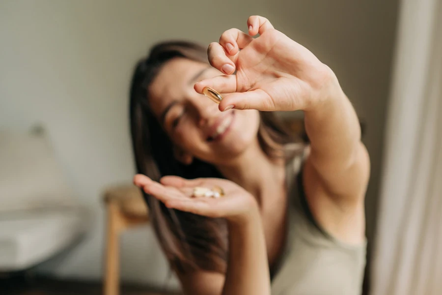 Woman showing eye care skin supplements