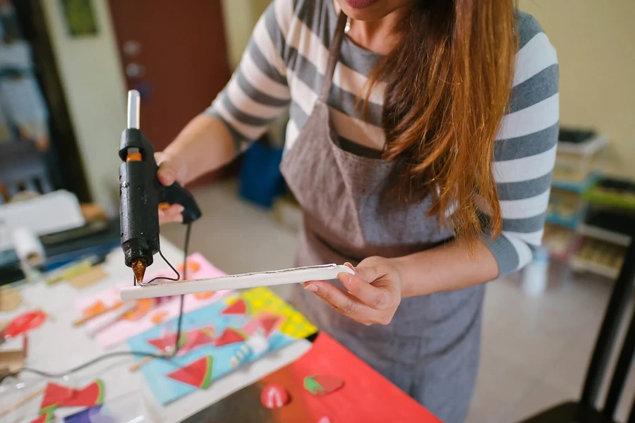 Woman using hot glue gun